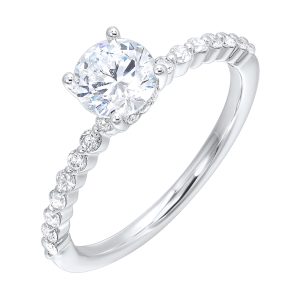 This lovely engagement ring consists of brilliant cut center diamond with single prong set diamonds along the shank and finishing touches of added diamonds details in front.
