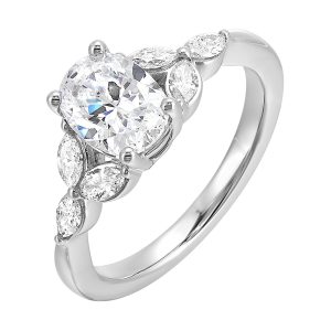 Elongated oval diamond takes center stage, framed by graceful trinity of marquise diamonds set on either side followed by a pinch shank is sure to flatten her.